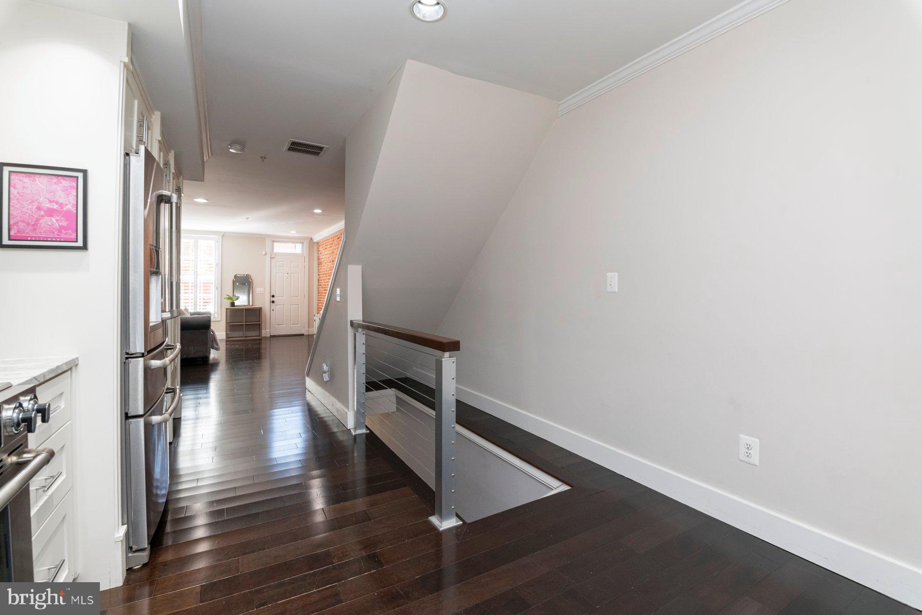 1237 William Street Baltimore, MD 21230 - Photo 8 of 34 a view of a hallway with wooden floor and a living room