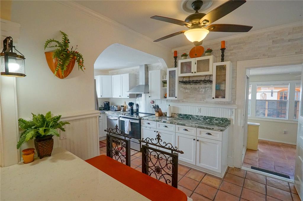 229 East 6th Avenue Mount Dora, FL 32757 - Photo 13 of 65 a kitchen with stainless steel appliances granite countertop a stove a sink a dining table and chairs