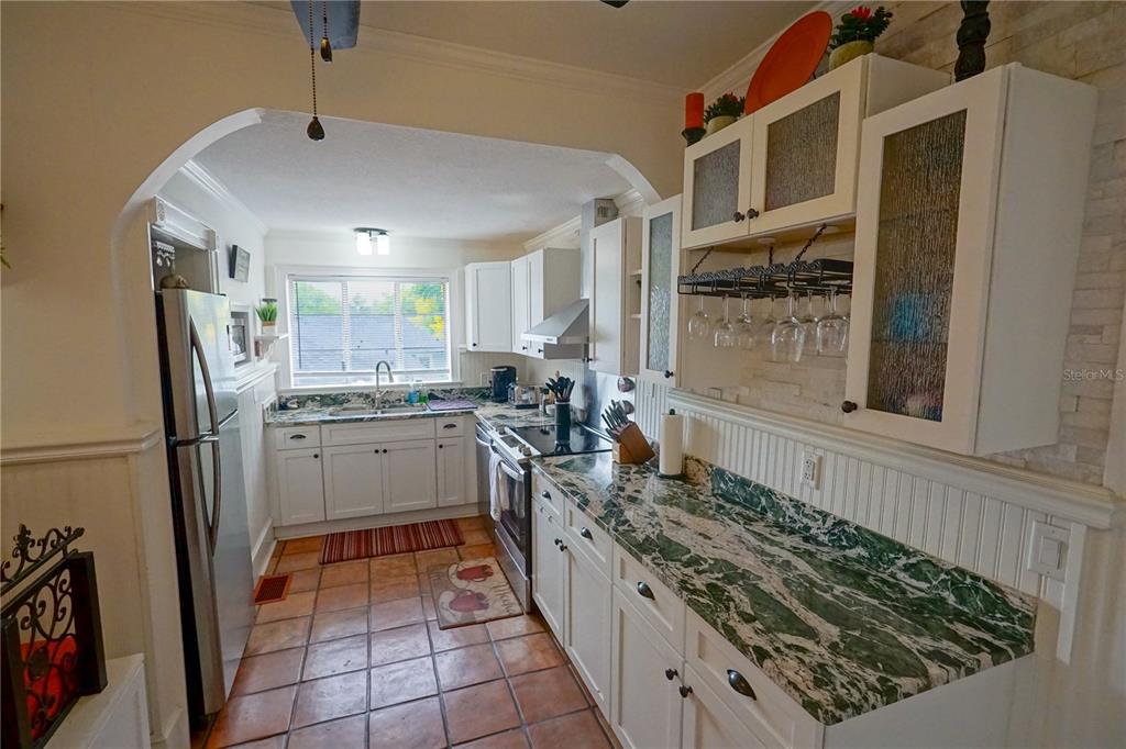 229 East 6th Avenue Mount Dora, FL 32757 - Photo 14 of 65 a kitchen with stainless steel appliances granite countertop a stove a sink and a refrigerator