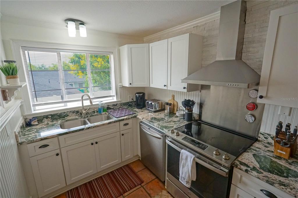 229 East 6th Avenue Mount Dora, FL 32757 - Photo 15 of 65 a kitchen with a sink stove and cabinets