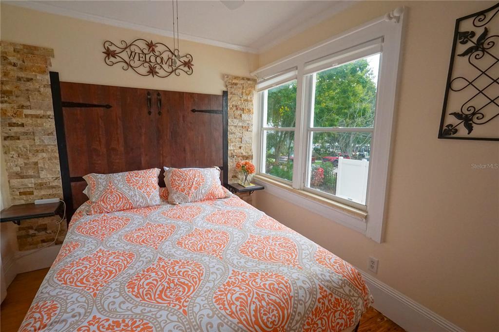 229 East 6th Avenue Mount Dora, FL 32757 - Photo 23 of 65 a large bed sitting in a bedroom next to a window
