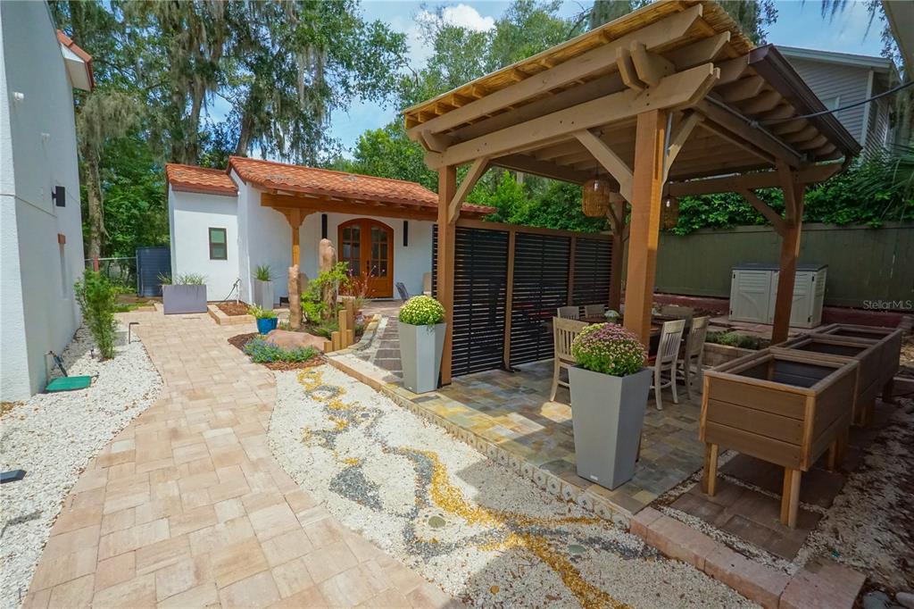 229 East 6th Avenue Mount Dora, FL 32757 - Photo 33 of 65 a view of a patio with a table chairs and a small yard