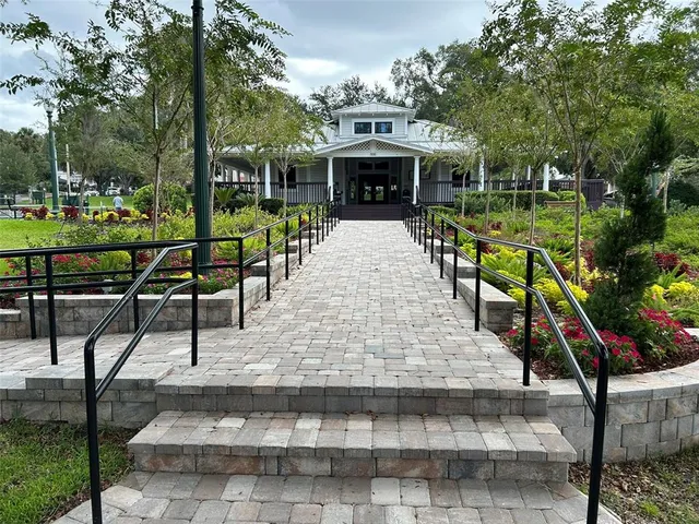 a bedroom with a bed and a flat tv screen on the dresser