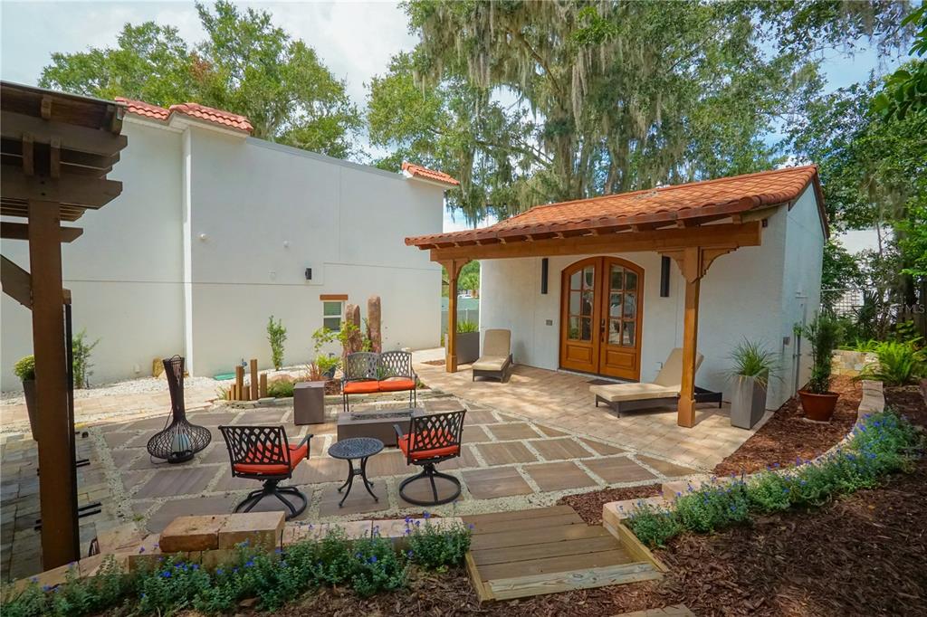 229 East 6th Avenue Mount Dora, FL 32757 - Photo 49 of 65 a view of a patio with table and chairs and potted plants