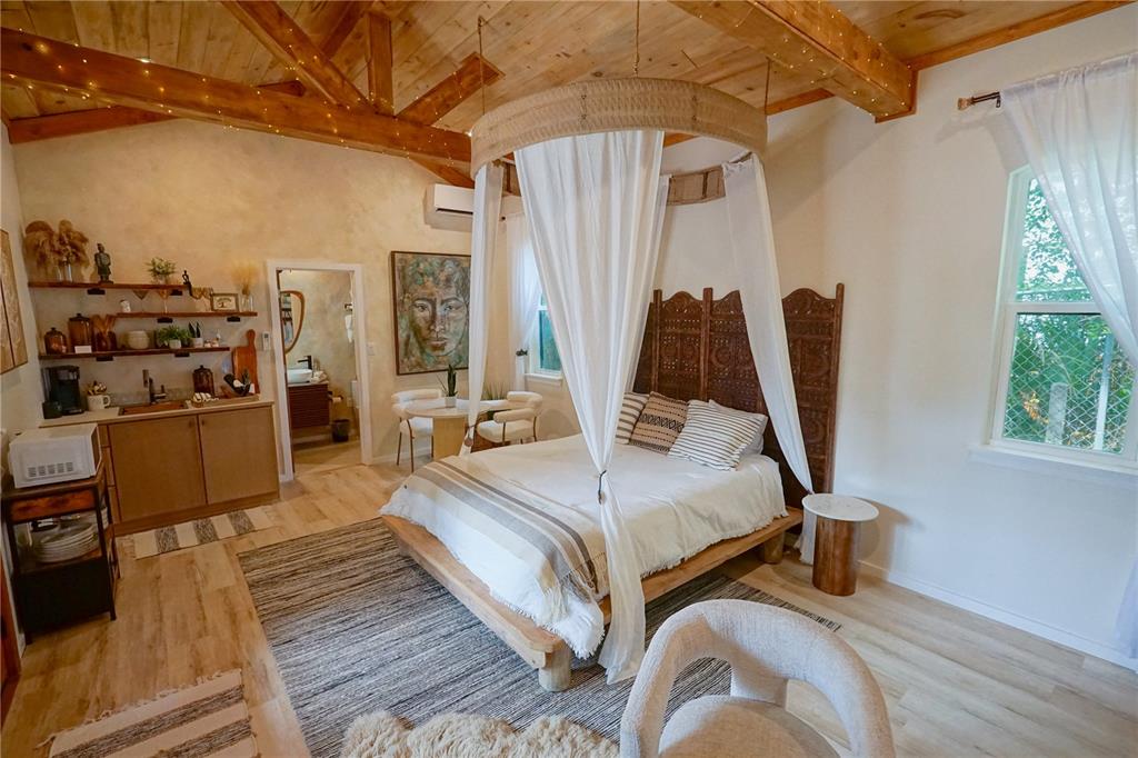 229 East 6th Avenue Mount Dora, FL 32757 - Photo 52 of 65 a bedroom with a bed and a flat tv screen on the dresser