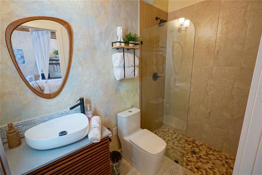 229 East 6th Avenue Mount Dora, FL 32757 - Photo 58 of 65 a bathroom with a toilet a sink and a mirror