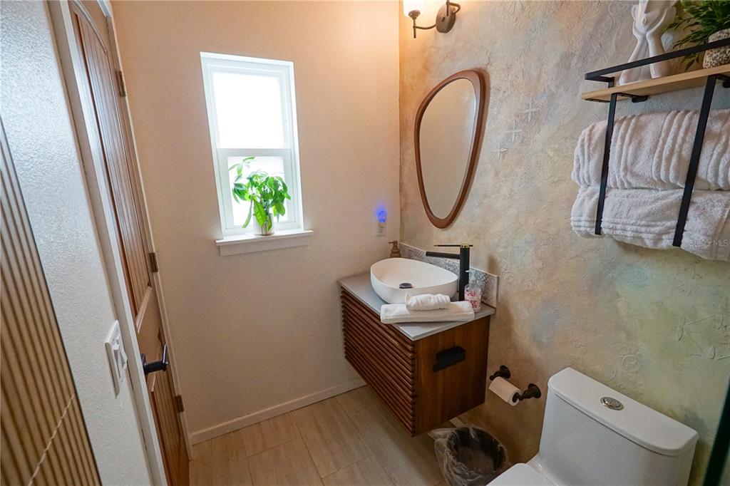 229 East 6th Avenue Mount Dora, FL 32757 - Photo 59 of 65 a bathroom with a sink toilet and a mirror