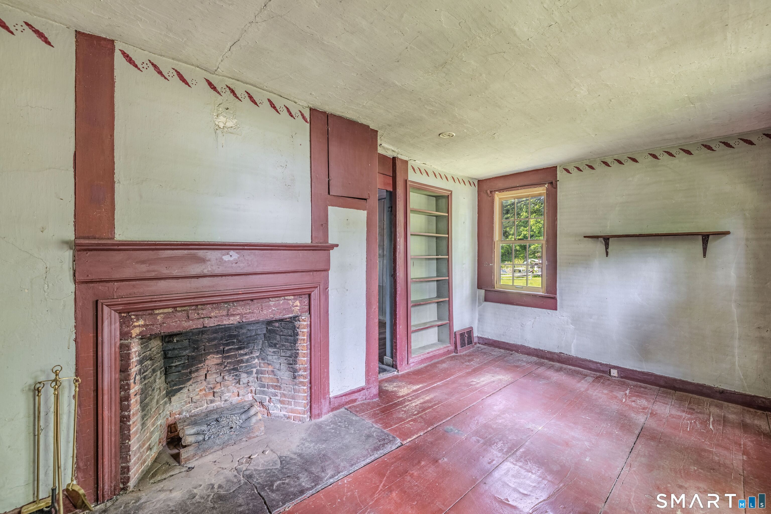 261 Hebron Road Bolton, CT 06043 - Photo 18 of 40 a view of an empty room with window and fire place