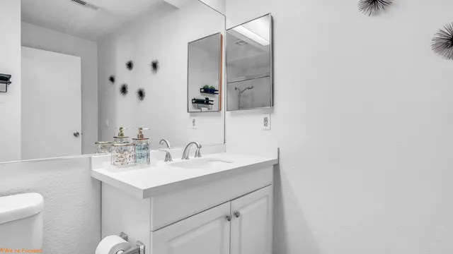 a bathroom with a sink toilet and mirror