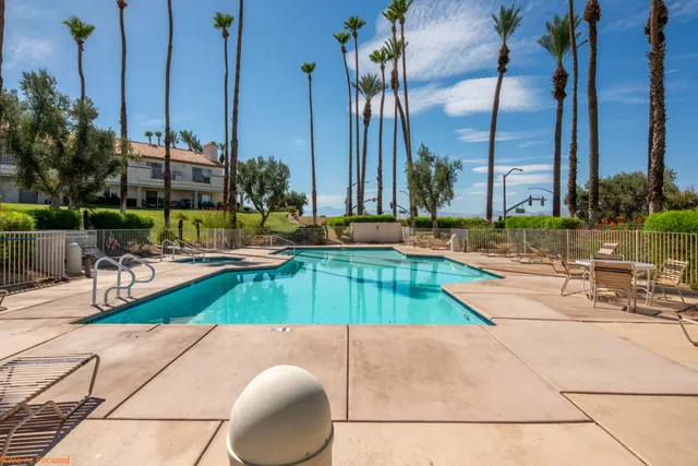 a view of a swimming pool with a lounge chairs