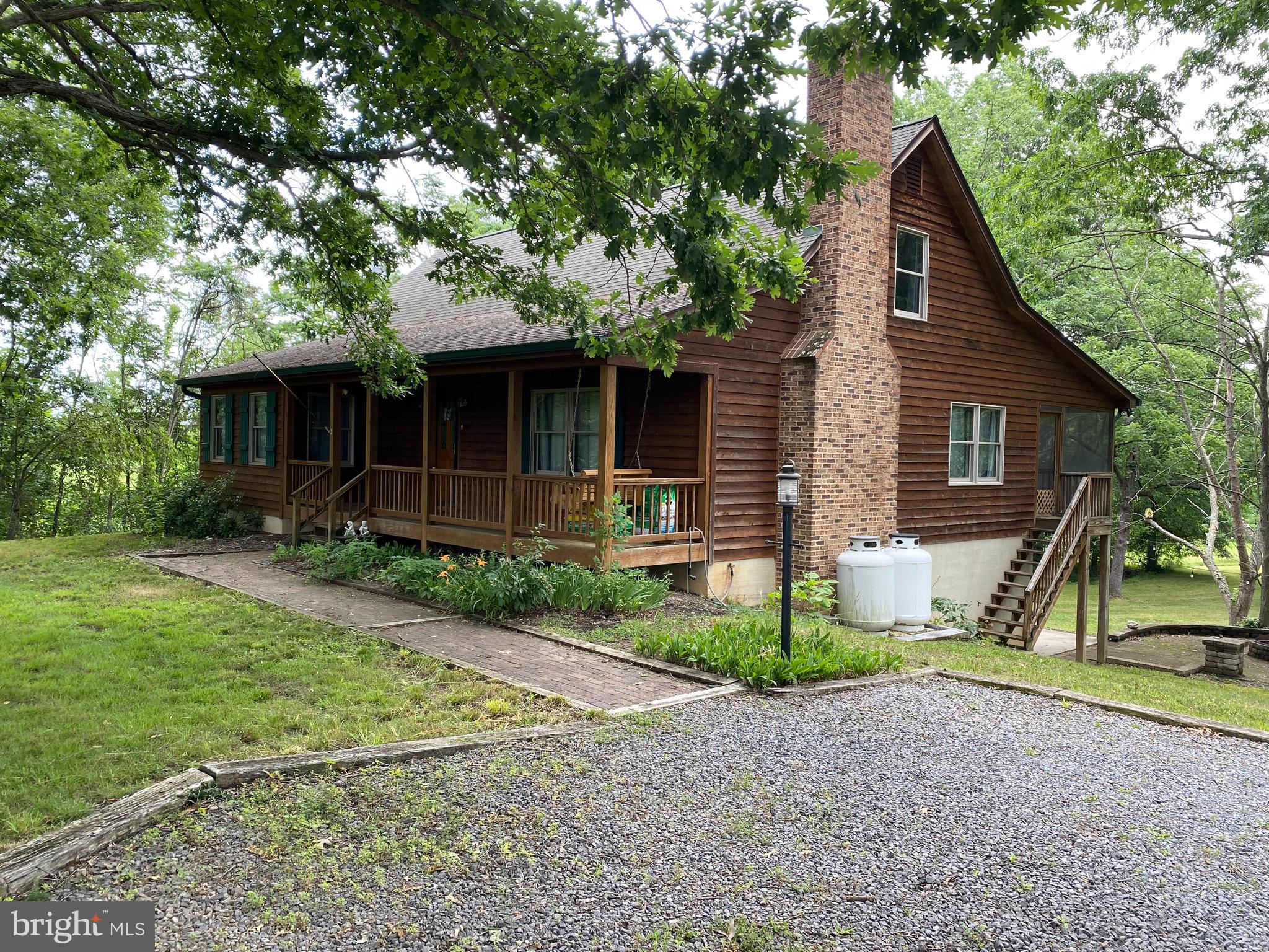 1909 Back Mountain Road Winchester, VA 22602 - Photo 1 of 28 a front view of a house with a yard and garage