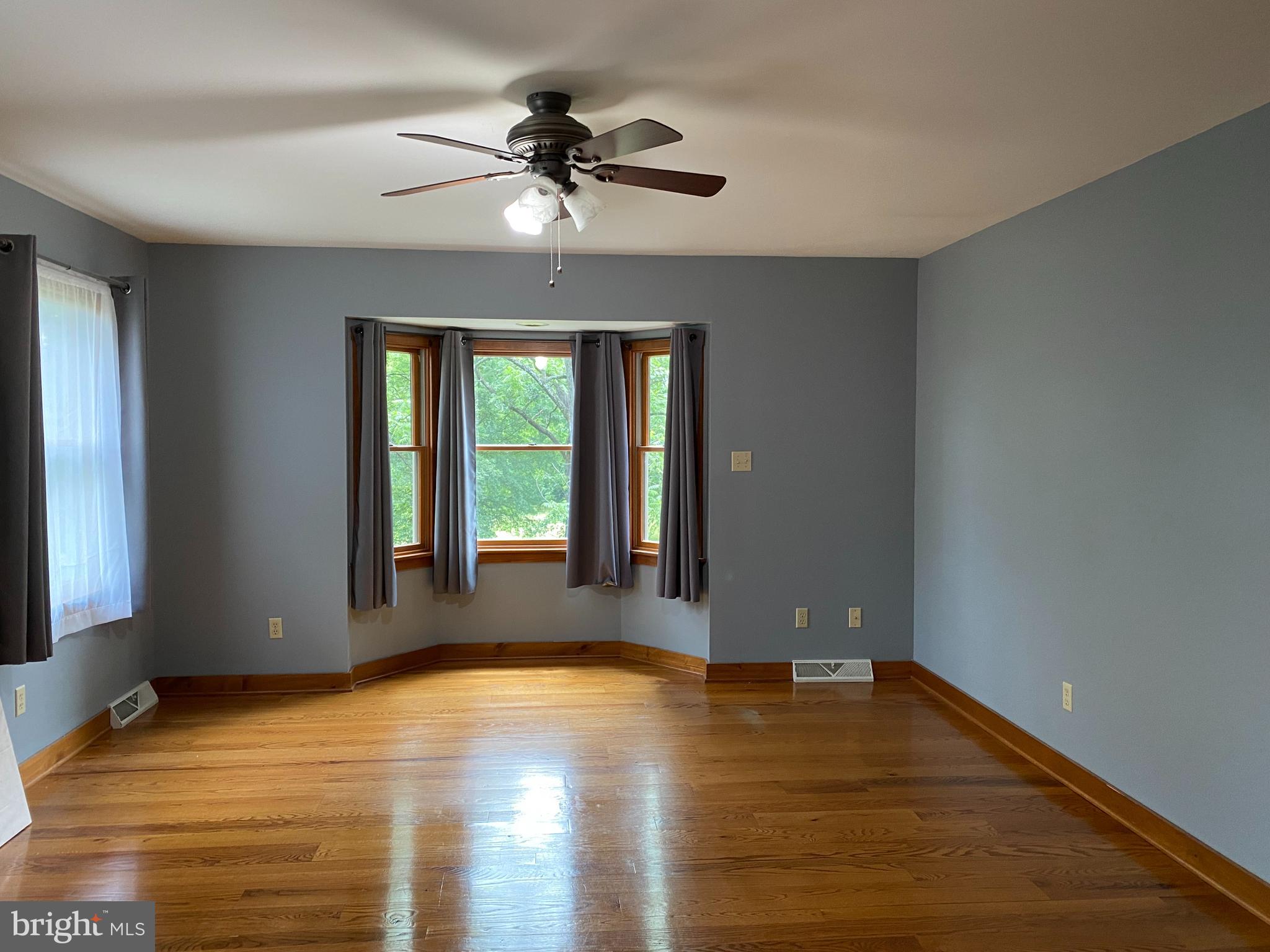 1909 Back Mountain Road Winchester, VA 22602 - Photo 13 of 28 a view of empty room with wooden floor and fan
