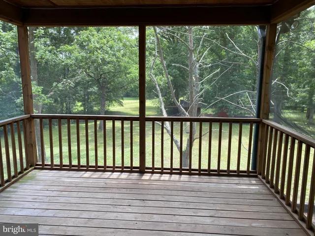a view of a wooden deck next to a yard