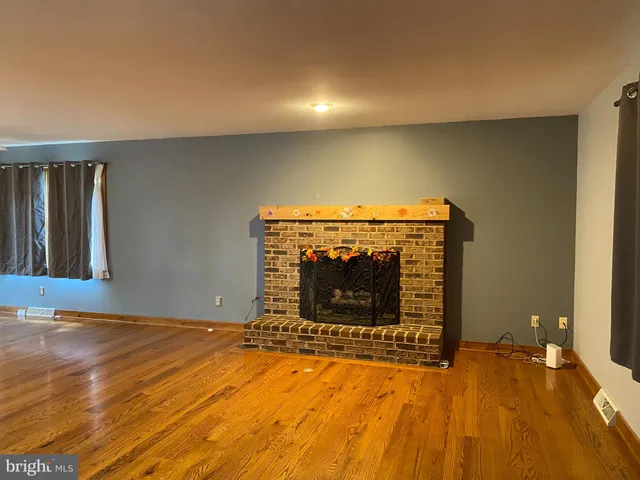 a view of empty room with a fireplace