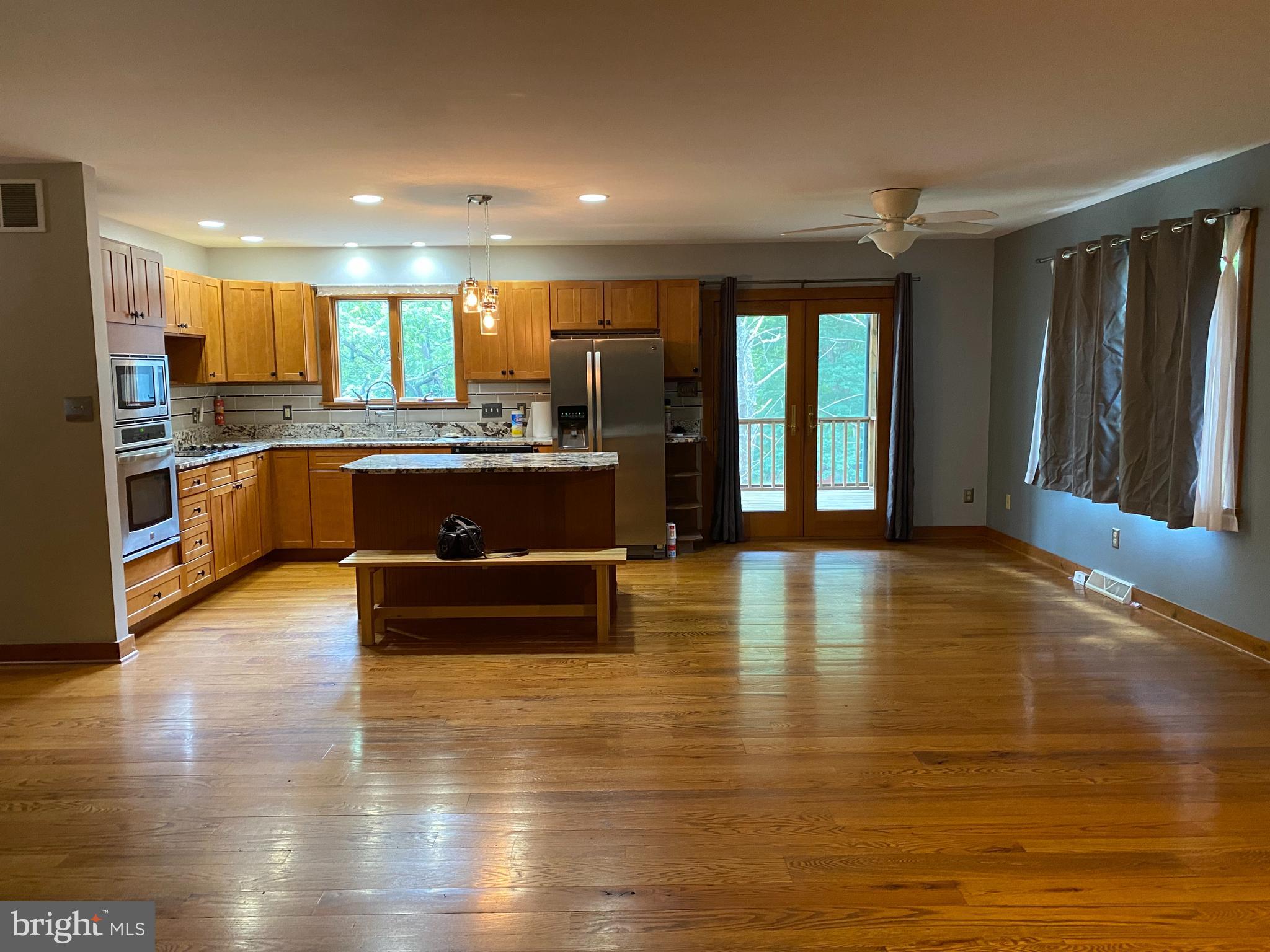 1909 Back Mountain Road Winchester, VA 22602 - Photo 7 of 28 a living room with stainless steel appliances granite countertop a refrigerator and a large window