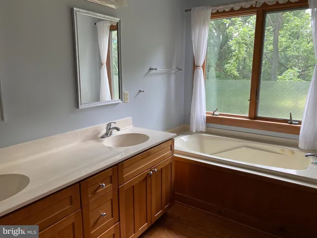 a bathroom with a sink and a window
