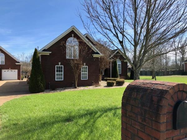 702 Heritage Road Lebanon, TN 37087 - Photo 3 of 25 a front view of a house with a yard and garage
