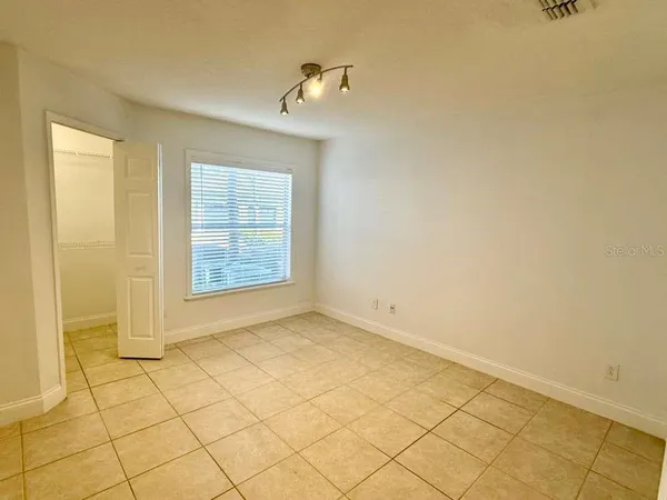 a view of an empty room and a window