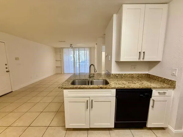 a kitchen with a sink and cabinets