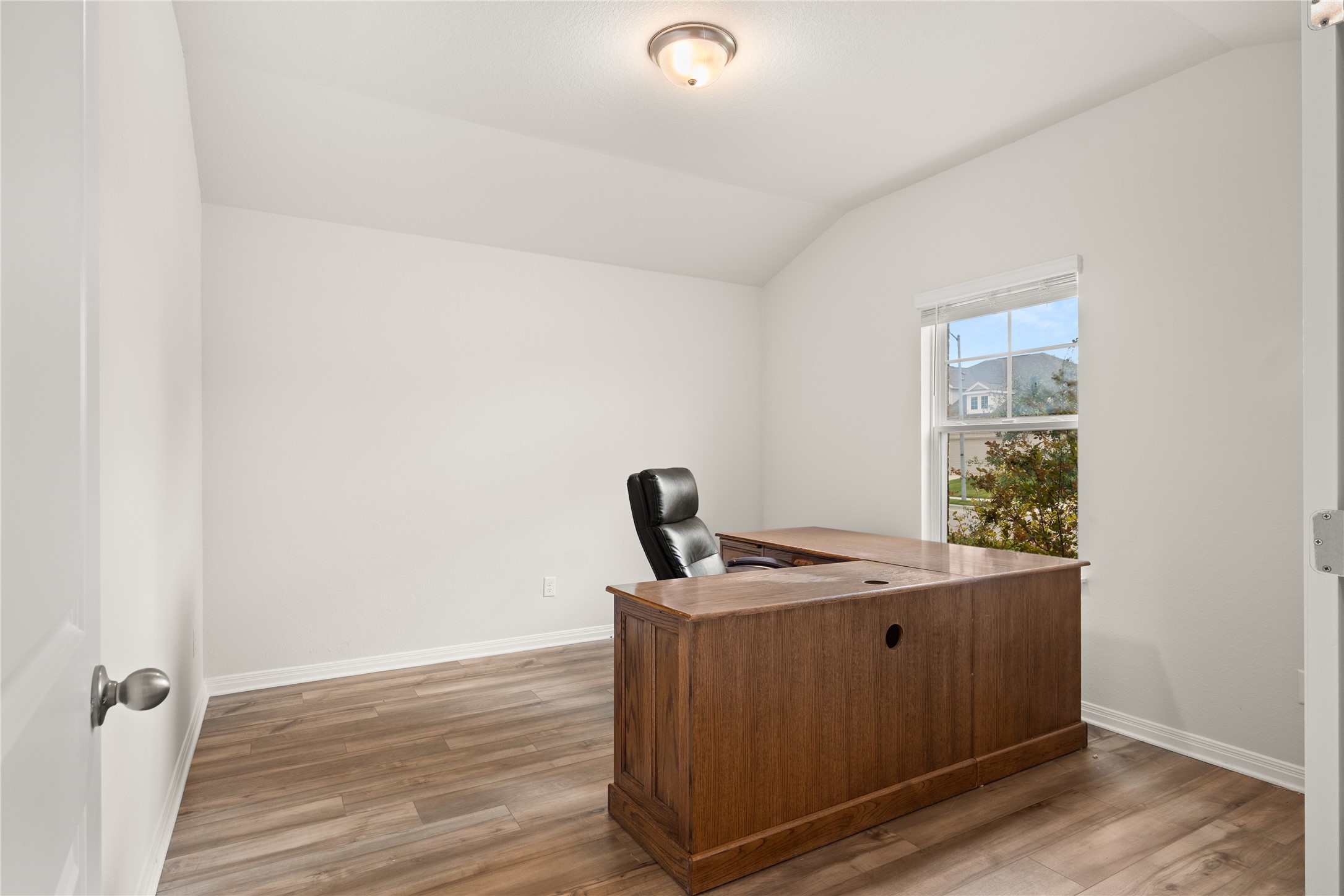 105 Saviano Road Hutto, TX 78634 - Photo 15 of 22 Dedicarted Office with French Doors: A quiet study space boasts elevated ceilings and resilient vinyl flooring.
