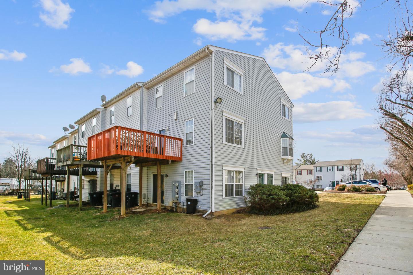 1670 Brooksquare Drive, Unit 54 Capitol Heights, MD 20743 - Photo 2 of 28 a view of a building with a yard
