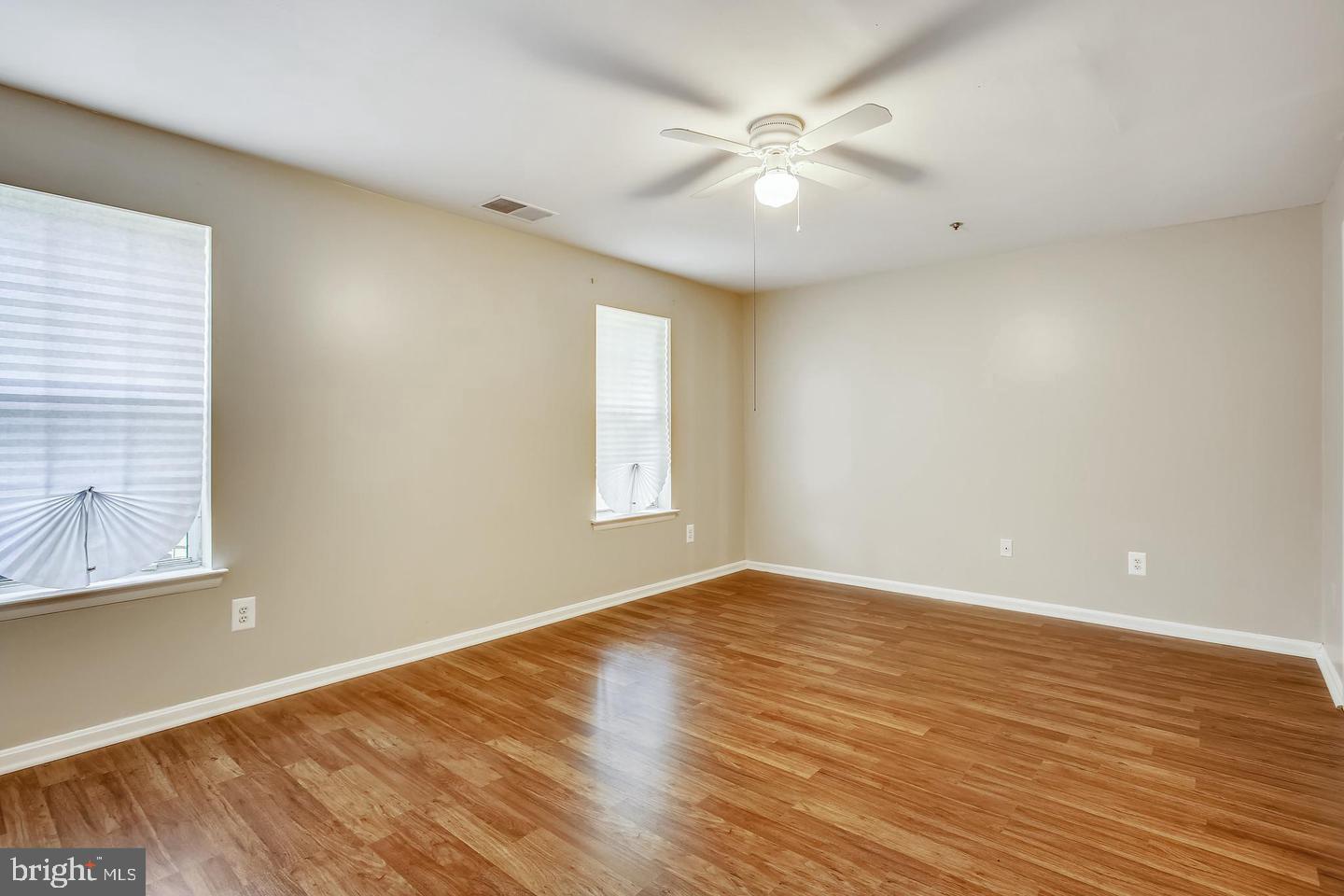 1670 Brooksquare Drive, Unit 54 Capitol Heights, MD 20743 - Photo 24 of 28 an empty room with wooden floor and windows