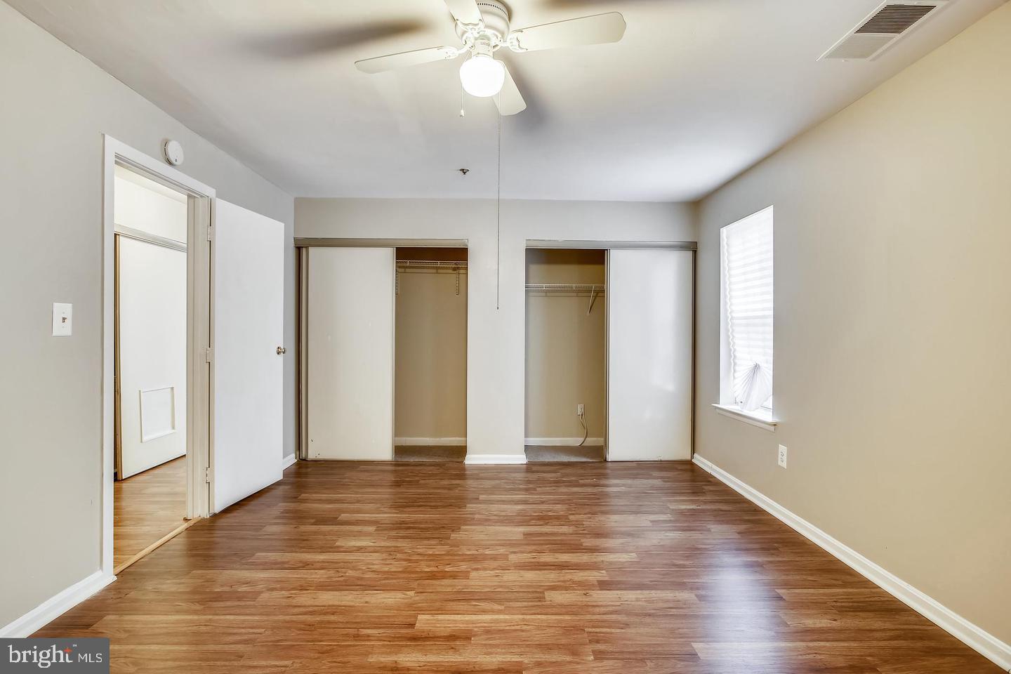 1670 Brooksquare Drive, Unit 54 Capitol Heights, MD 20743 - Photo 27 of 28 an empty room with wooden floor and windows