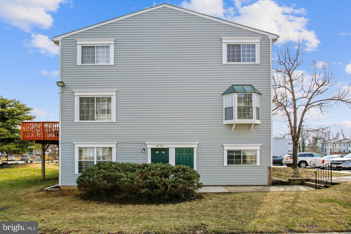 1670 Brooksquare Drive, Unit 54 Capitol Heights, MD 20743 - Photo 28 of 28 a view of a house with a yard plants and large tree