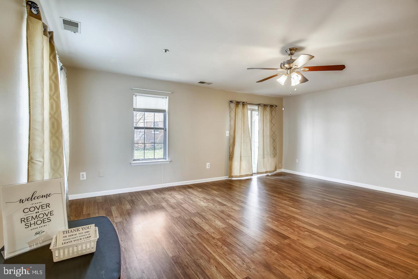 1670 Brooksquare Drive, Unit 54 Capitol Heights, MD 20743 - Photo 3 of 28 a view of an empty room with a window and wooden floor