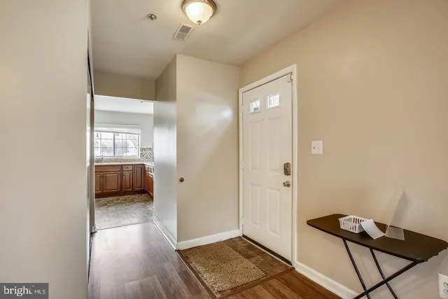 a view of a hallway to a livingroom with furniture