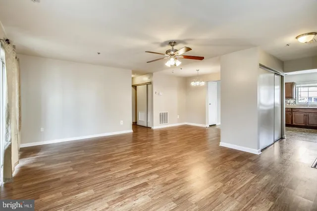 a view of an empty room with wooden floor