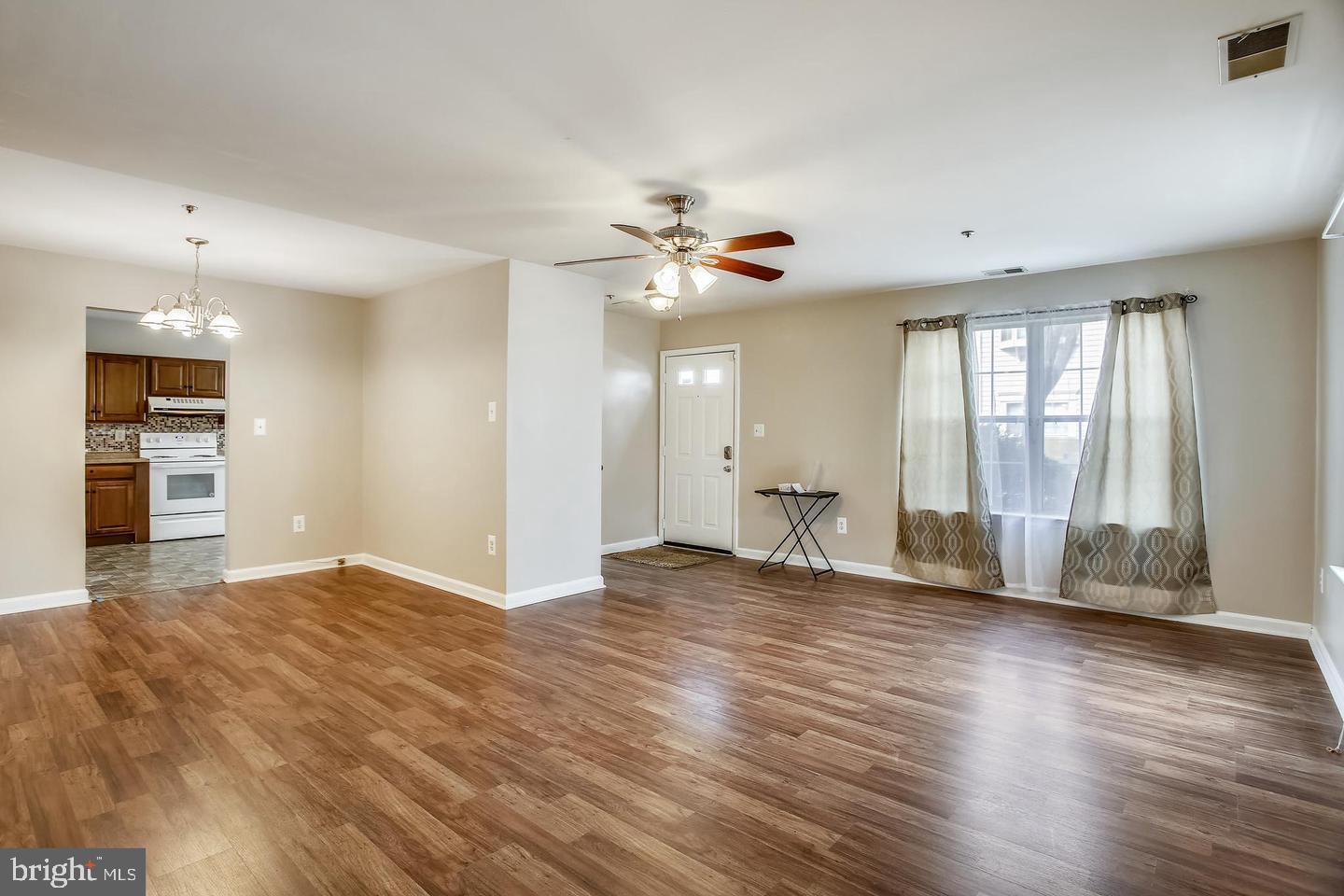 1670 Brooksquare Drive, Unit 54 Capitol Heights, MD 20743 - Photo 7 of 28 a view of an empty room with a window and wooden floor