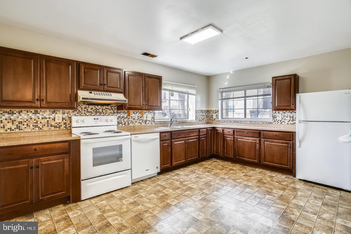 1670 Brooksquare Drive, Unit 54 Capitol Heights, MD 20743 - Photo 8 of 28 a kitchen with stainless steel appliances granite countertop a stove sink and cabinets