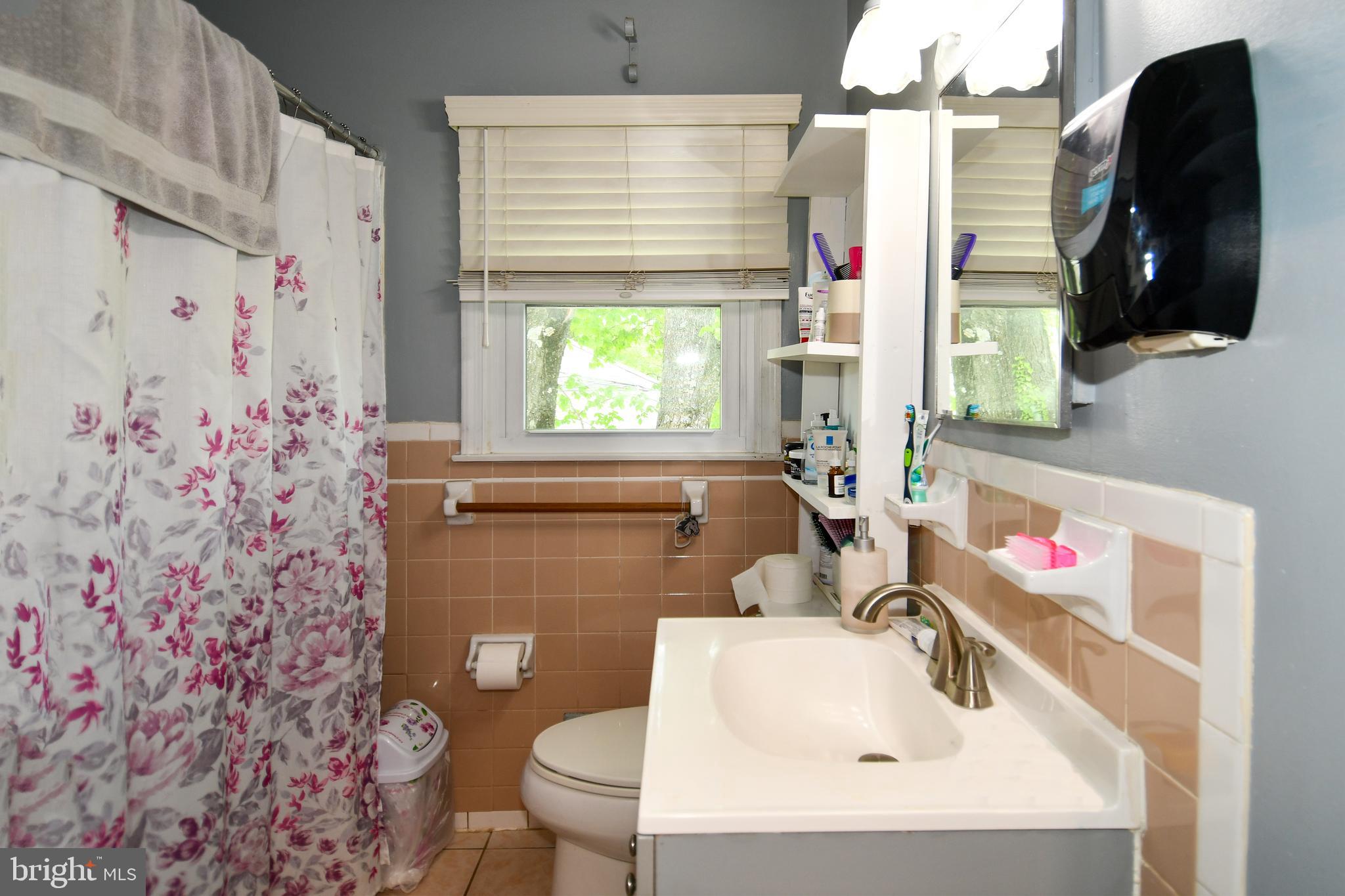 6114 Osborn Road Landover, MD 20785 - Photo 13 of 38 a bathroom with a sink toilet and a mirror