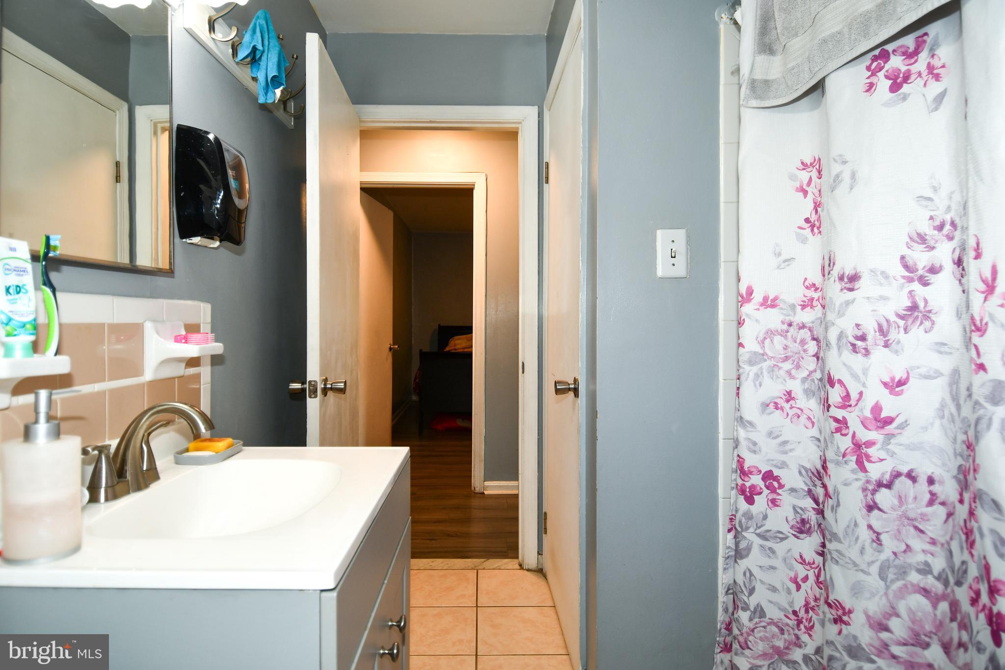 6114 Osborn Road Landover, MD 20785 - Photo 14 of 38 a bathroom with a sink vanity and shower