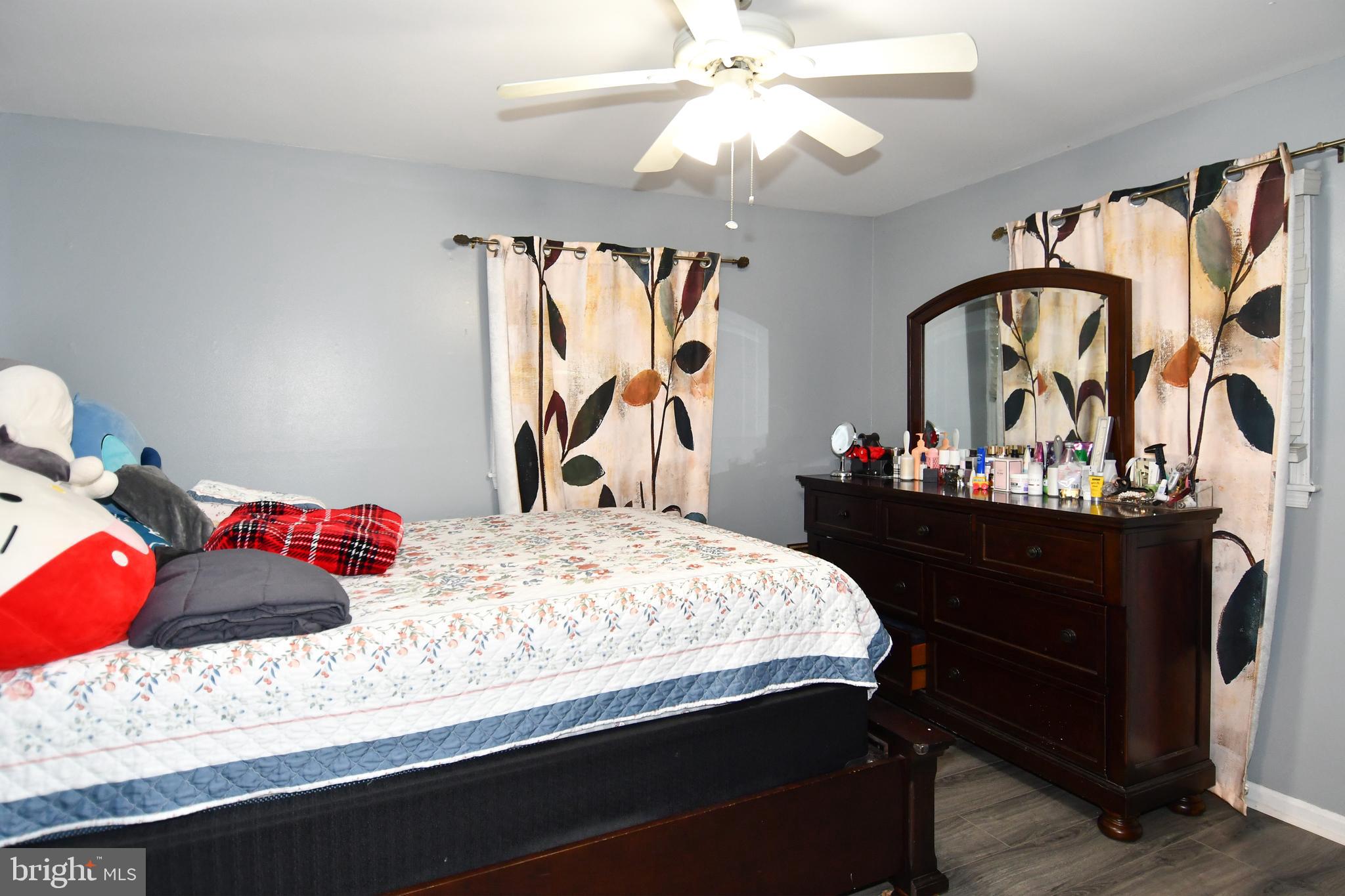 6114 Osborn Road Landover, MD 20785 - Photo 17 of 38 a bedroom with a bed and a chandelier