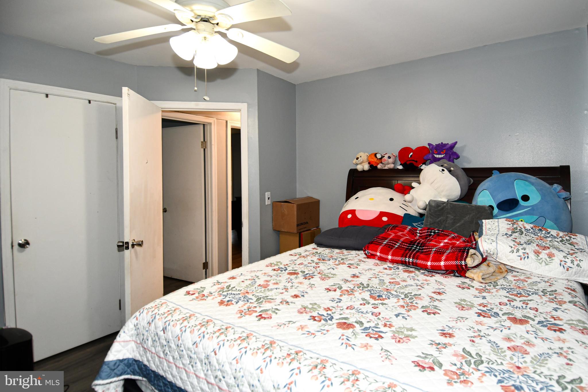 6114 Osborn Road Landover, MD 20785 - Photo 18 of 38 a bedroom with a bed and a chandelier