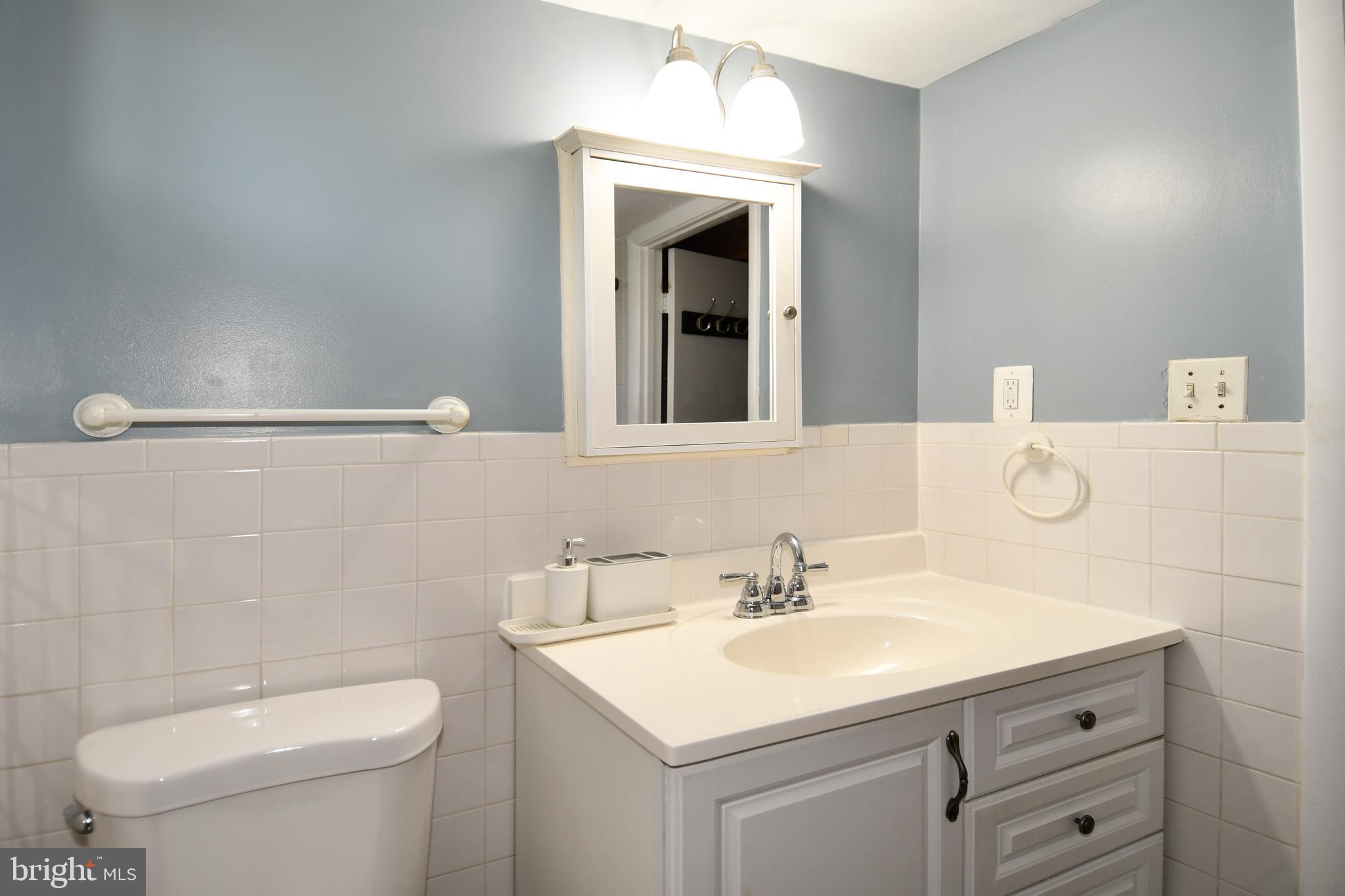 6114 Osborn Road Landover, MD 20785 - Photo 25 of 38 a bathroom with a sink toilet and mirror