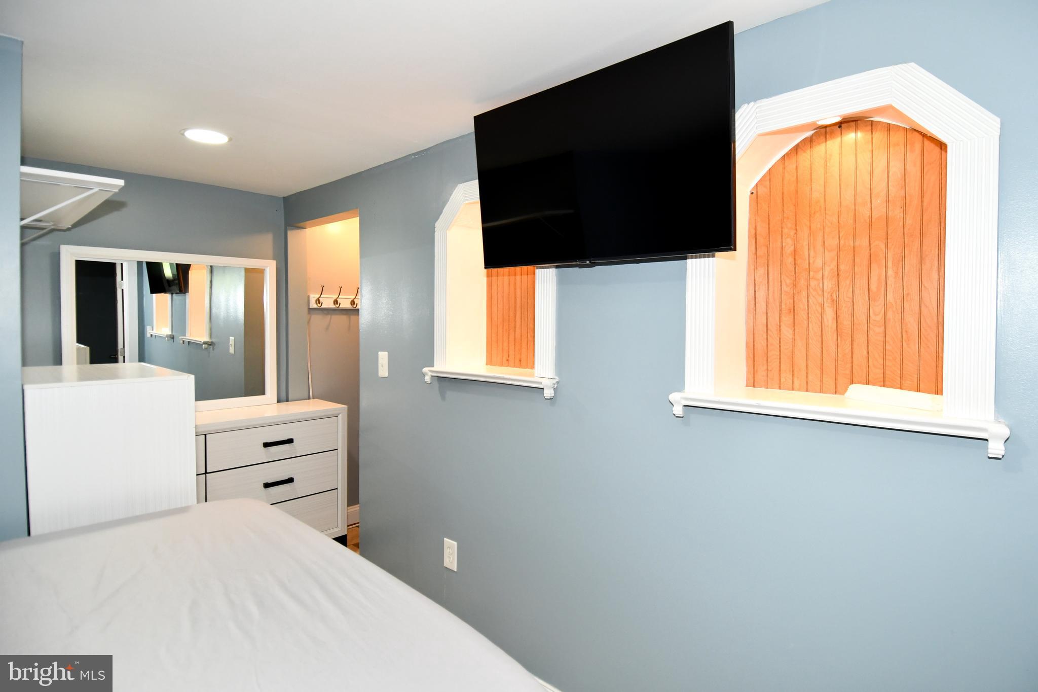 6114 Osborn Road Landover, MD 20785 - Photo 28 of 38 a bedroom with a bed and a flat tv screen on dresser