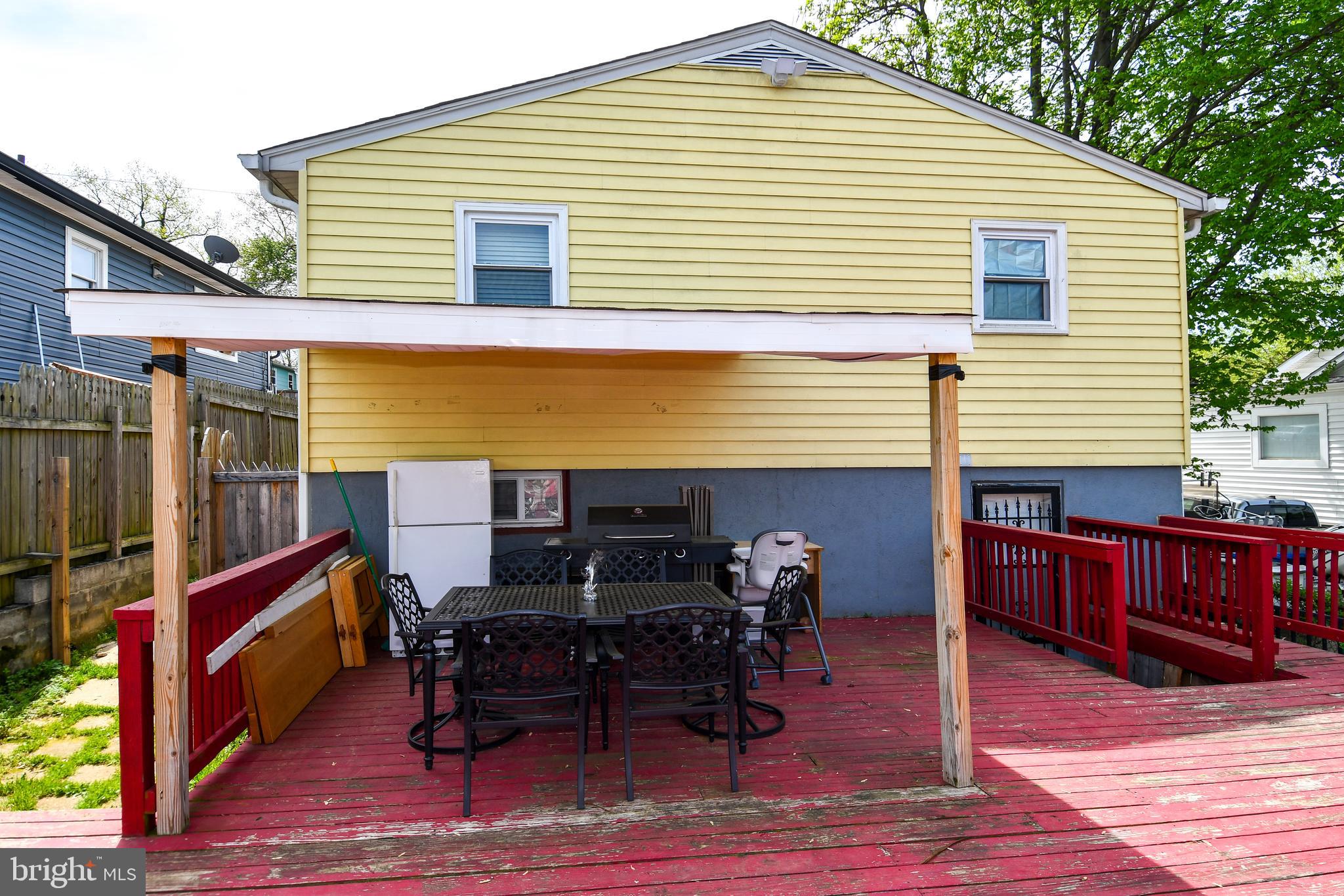 6114 Osborn Road Landover, MD 20785 - Photo 35 of 38 a backyard of a house with wooden floor chairs sofa and barbecue oven