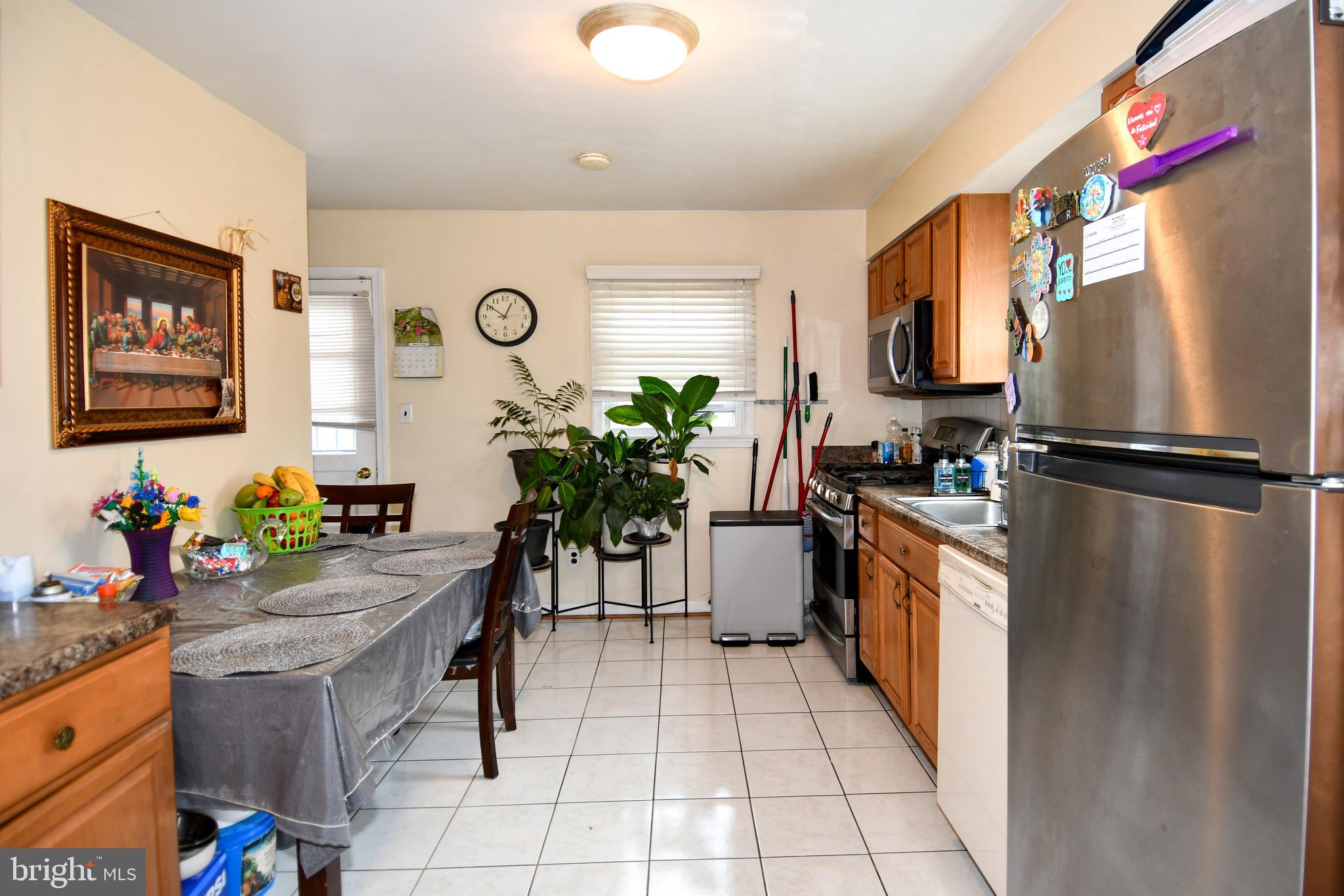 6114 Osborn Road Landover, MD 20785 - Photo 7 of 38 a kitchen with stainless steel appliances granite countertop a refrigerator and a sink