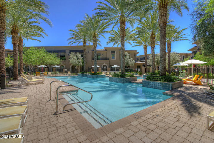 6565 East Thomas Road, Unit 1042 Scottsdale, AZ 85251 - Photo 18 of 22 a view of a backyard with swimming pool table and chairs