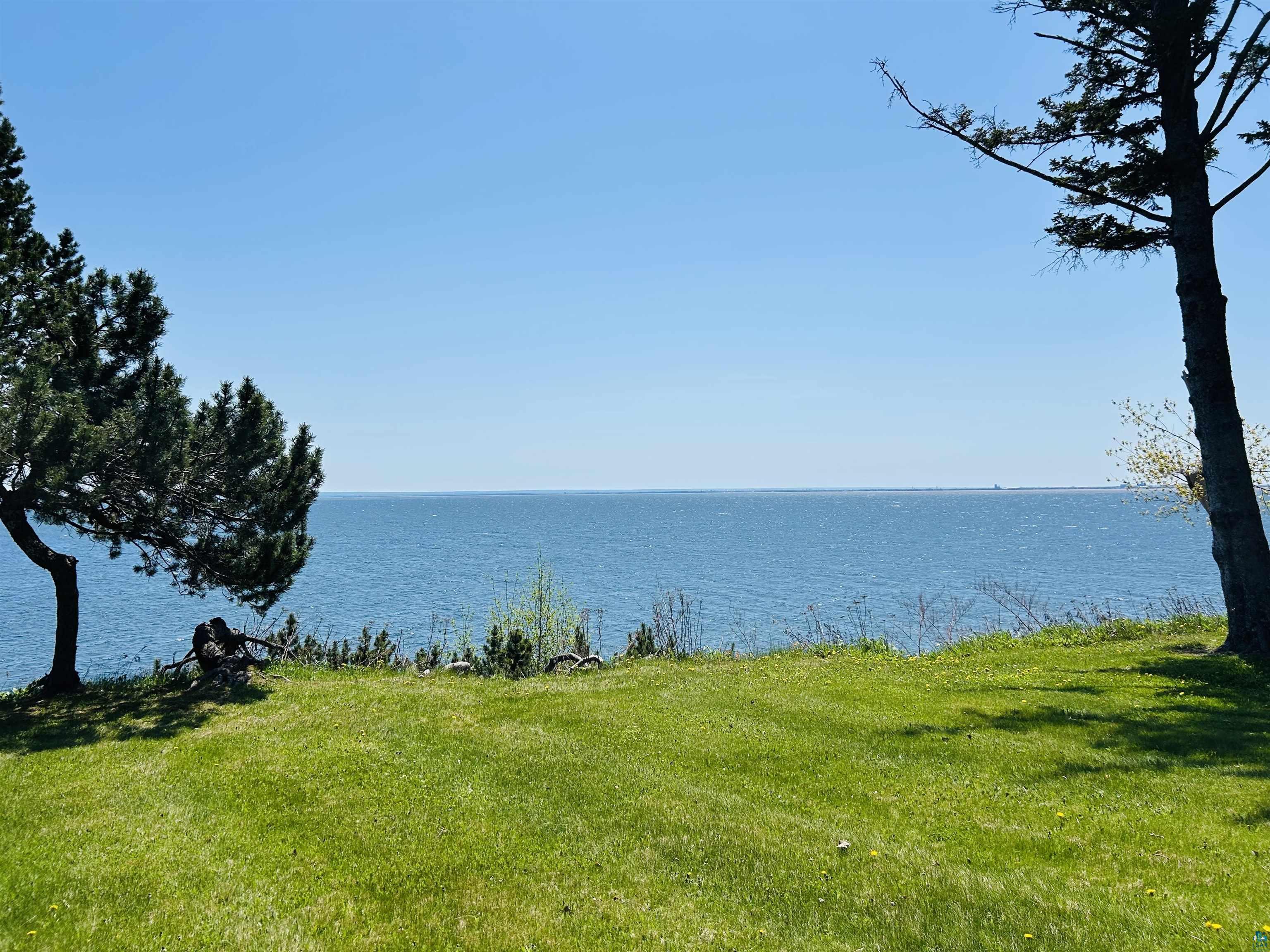 5090 London Road, Unit 1 Duluth, MN 55804 - Photo 44 of 54 Expansive lawn area presenting a significant body of water