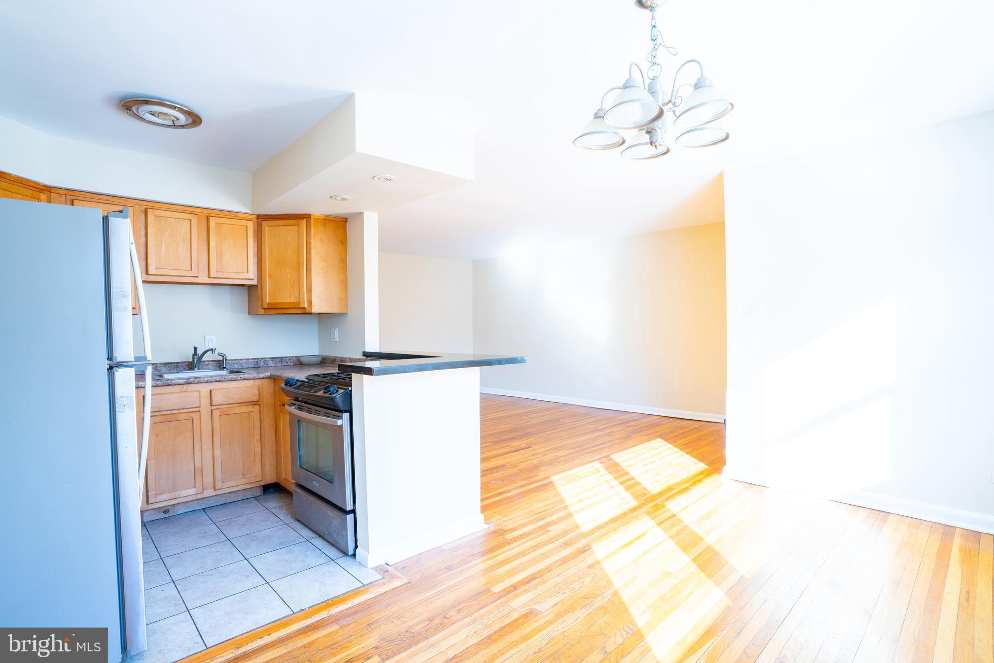 3717 Mimi Circle Philadelphia, PA 19131 - Photo 2 of 12 a kitchen with granite countertop a sink and a stove top oven