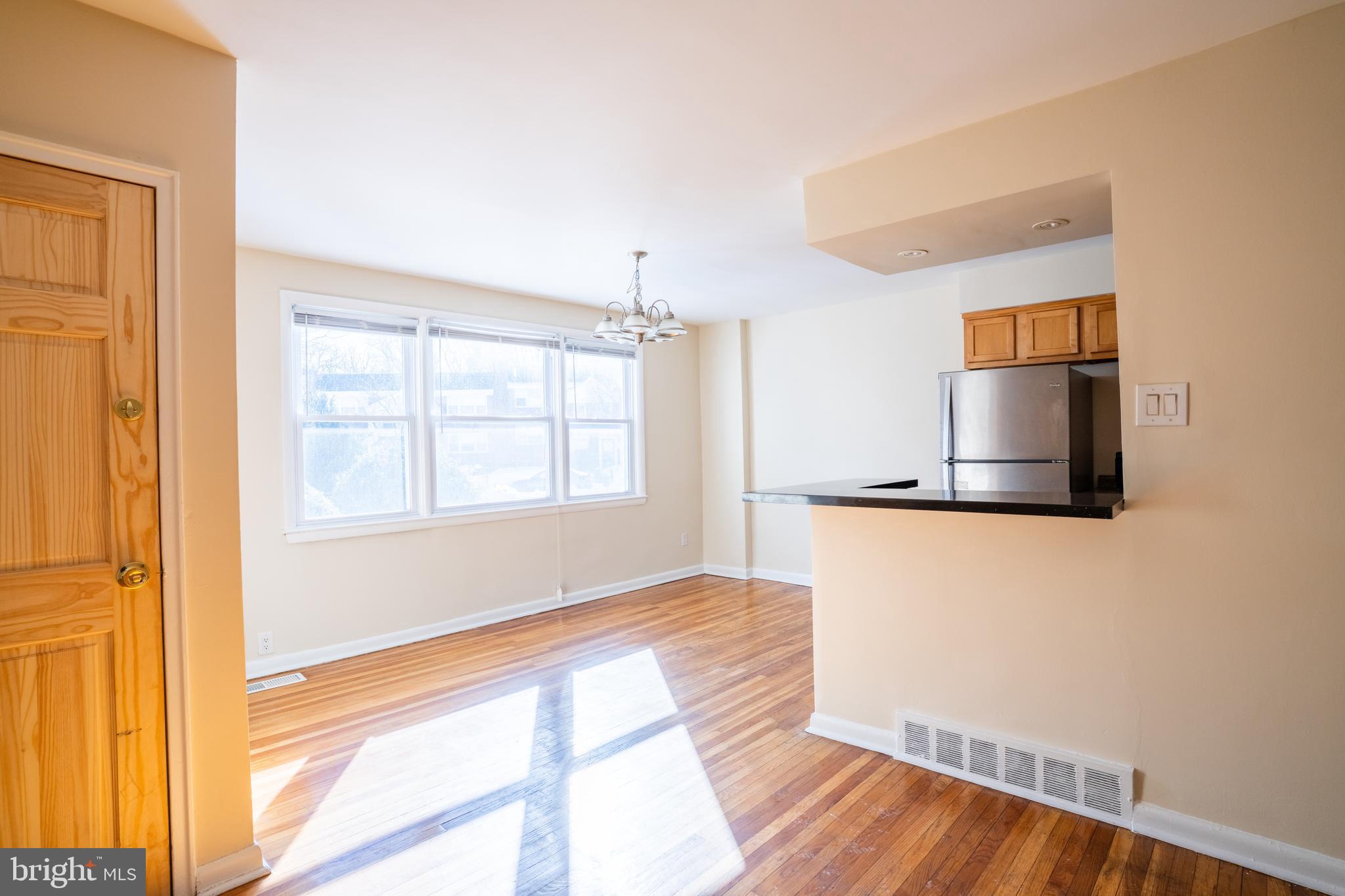 3717 Mimi Circle Philadelphia, PA 19131 - Photo 4 of 12 a view of an empty room with wooden floor and a window