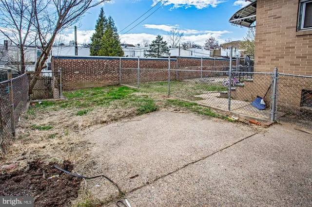 a view of backyard with wooden fence