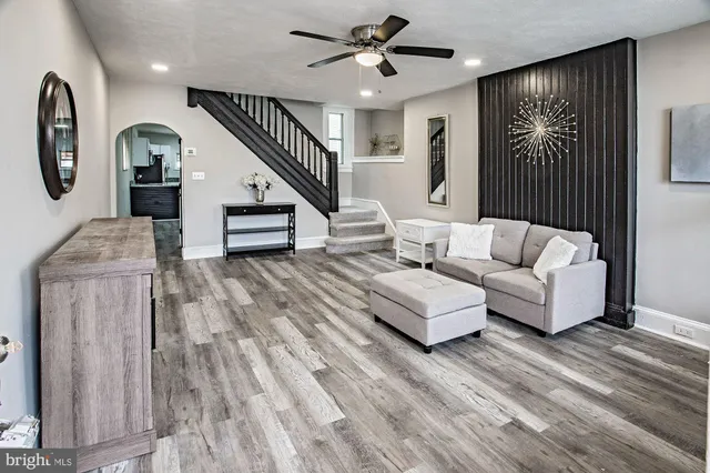 a living room with furniture and wooden floor