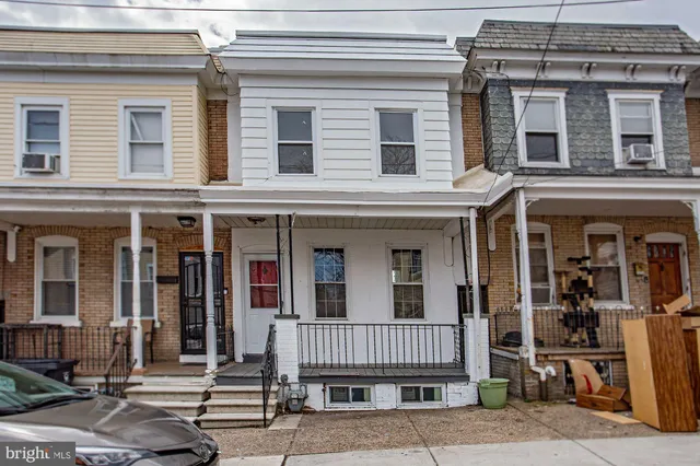 front view of a brick house with a large windows