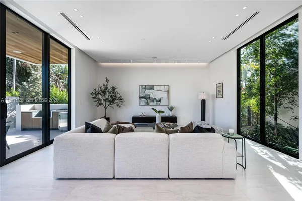 a large white kitchen with a large window