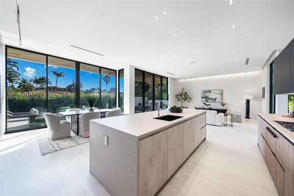 a living room with furniture a flat screen tv and a large window